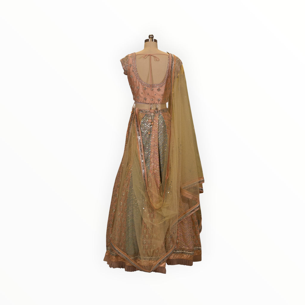 Zari Designs peach and mint green embroidered lehenga choli with mirror work and sheer dupatta on a mannequin