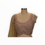 Zari Designs peach lehnga blouse with intricate mirror work and silver embroidery on a mannequin