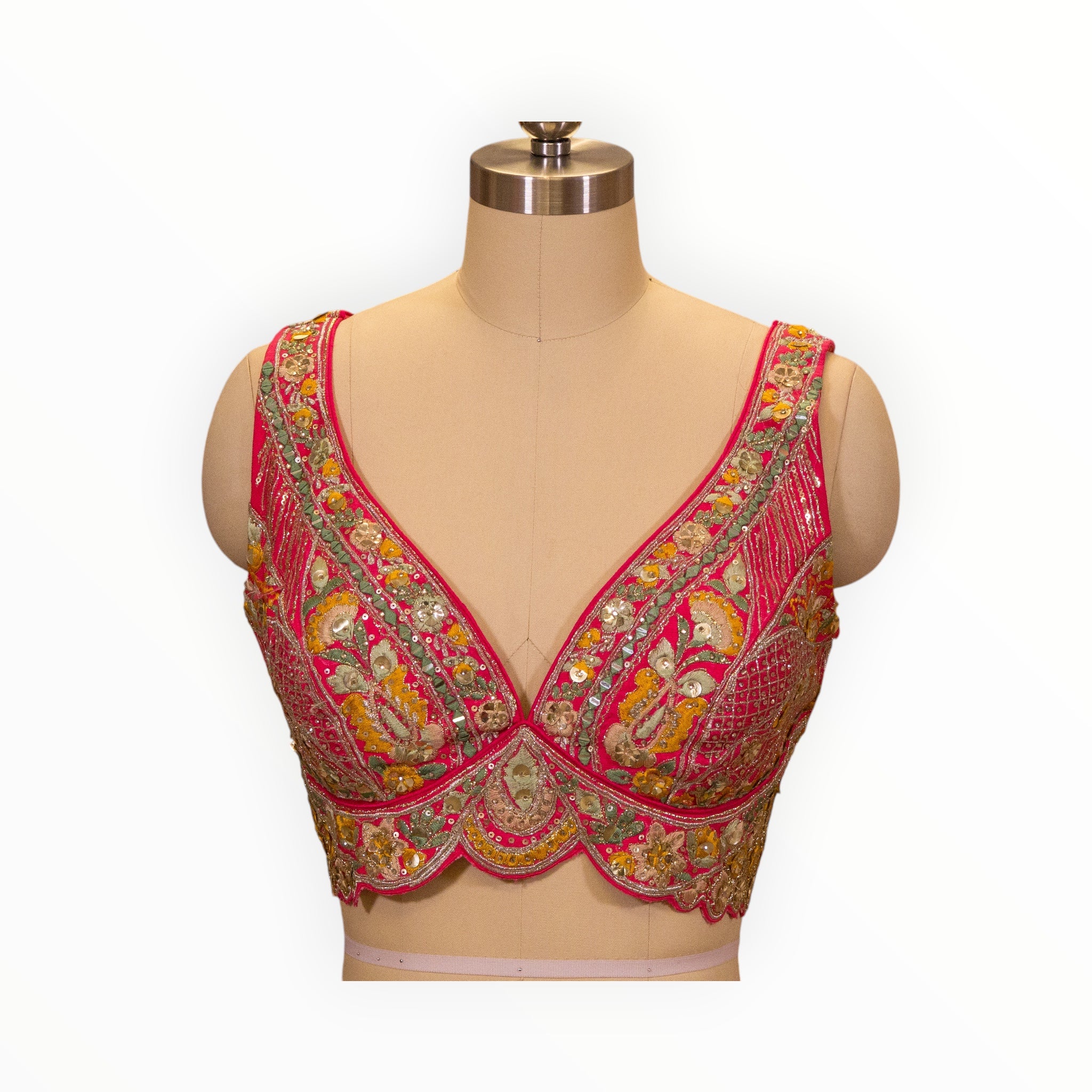 Zari Designs Carnival Lehnga blouse in vibrant pink with intricate multi-colored floral embroidery and sequin detailing.