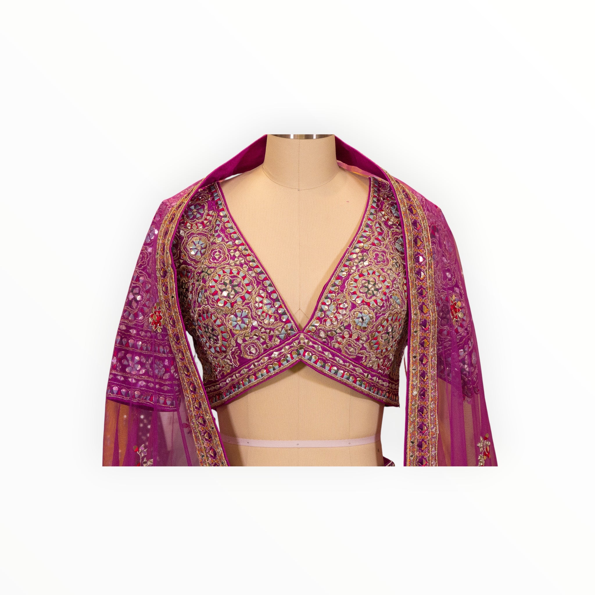 Zari Designs Carnival Lehnga featuring a deep pink blouse with intricate mirror work and embroidery on a mannequin
