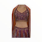 Zari Designs purple Banarsi lehenga with intricate floral embroidery, sequin work, and a matching orange dupatta.