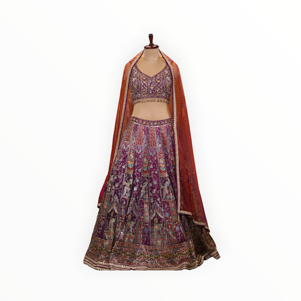 Zari Designs purple Banarsi lehenga with intricate embroidery, sequin work, and a sheer orange dupatta on a mannequin