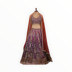 Zari Designs purple Banarsi lehenga with intricate embroidery, sequin work, and a sheer orange dupatta on a mannequin