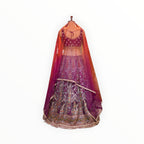Zari Designs purple Banarsi lehenga with intricate silver embroidery, sequins, and a sheer matching dupatta on a mannequin