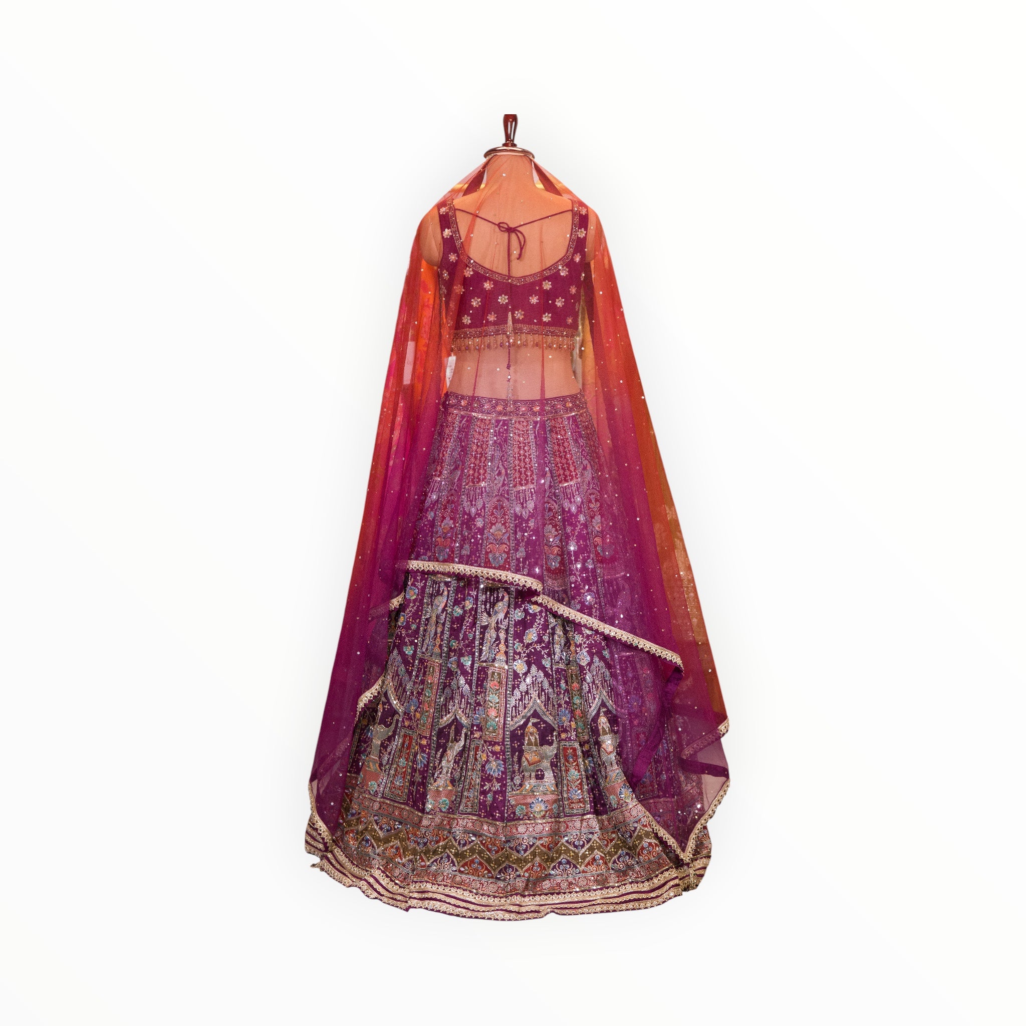 Zari Designs purple Banarsi lehenga with intricate silver embroidery, sequins, and a sheer matching dupatta on a mannequin