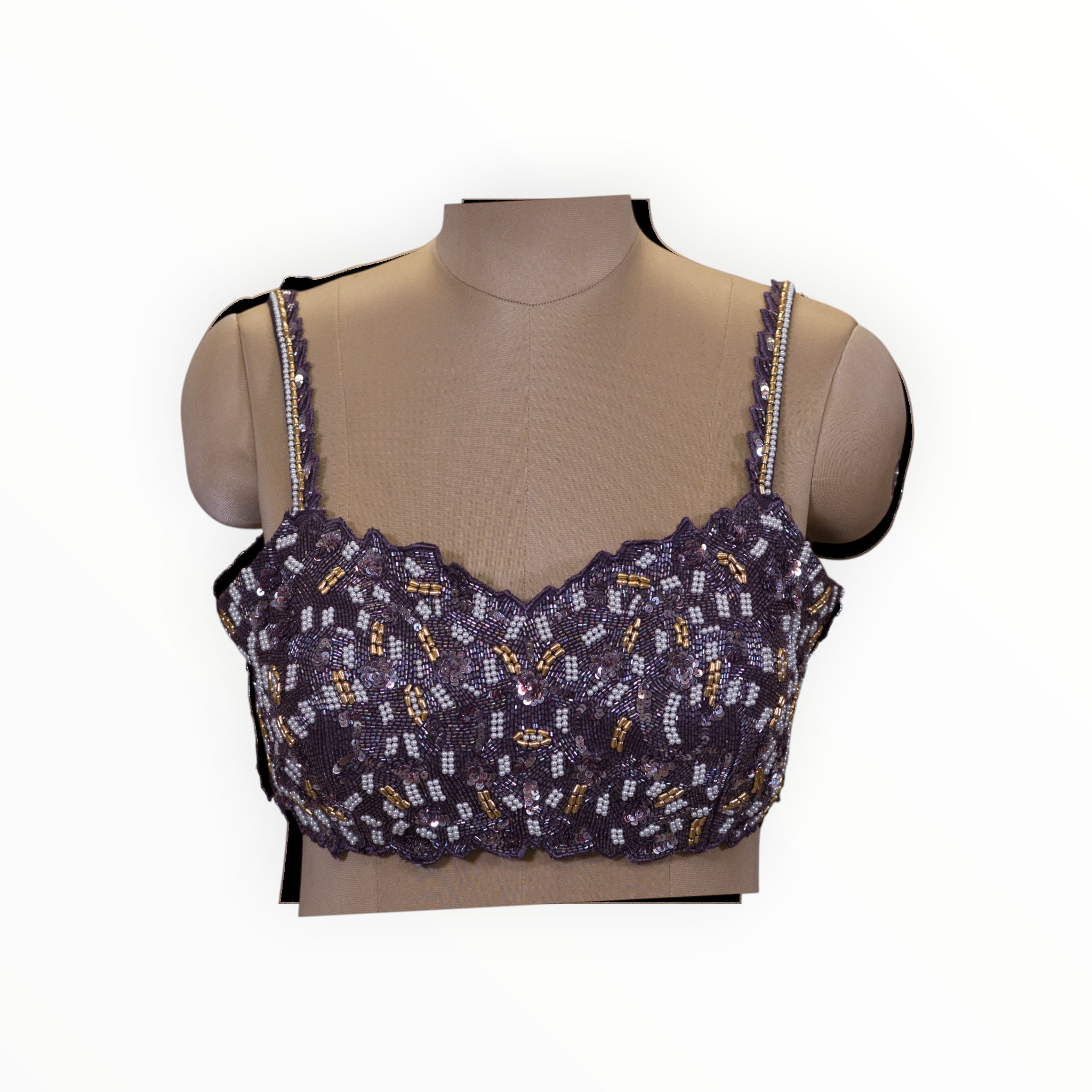 Zari Designs purple sleeveless blouse with intricate white and gold beadwork and sequin embellishments on a mannequin