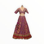 Zari Designs purple Carnival Lehnga with intricate gold embroidery, mirror work, and a deep V-neck blouse on a mannequin