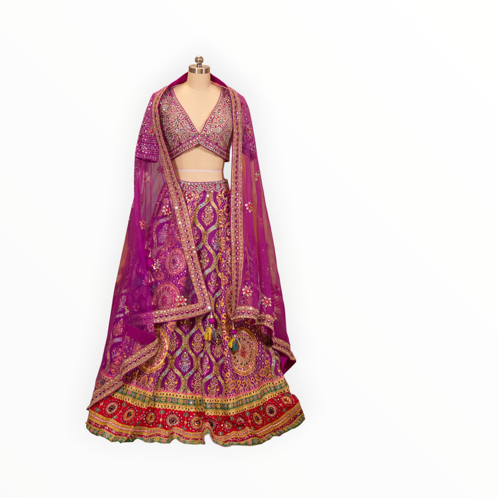 Zari Designs purple Carnival Lehnga with intricate gold embroidery, mirror work, and a matching sheer dupatta.