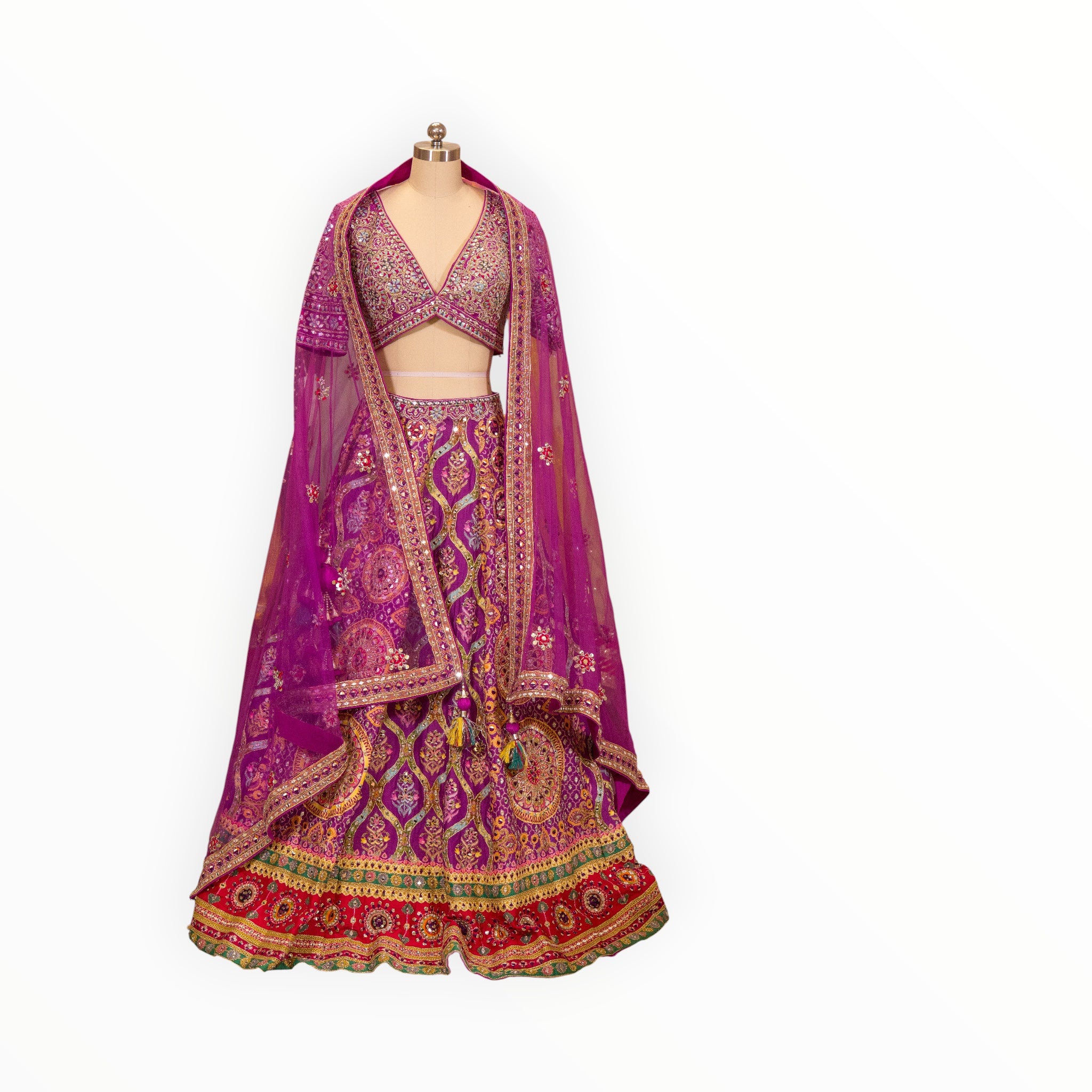 Zari Designs purple Carnival Lehnga with intricate gold embroidery, mirror work, and a matching sheer dupatta.