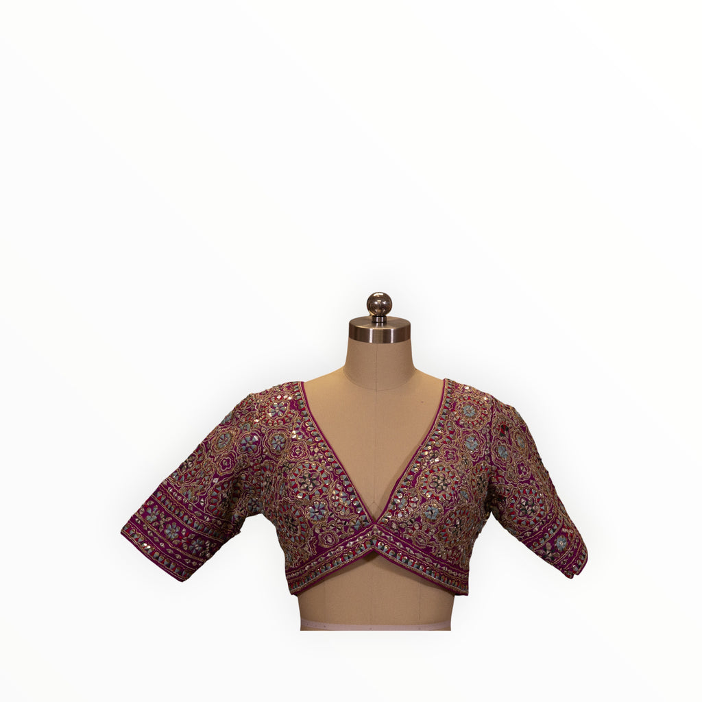 Zari Designs purple Carnival Lehnga blouse with intricate silver embroidery and mirror work on a mannequin