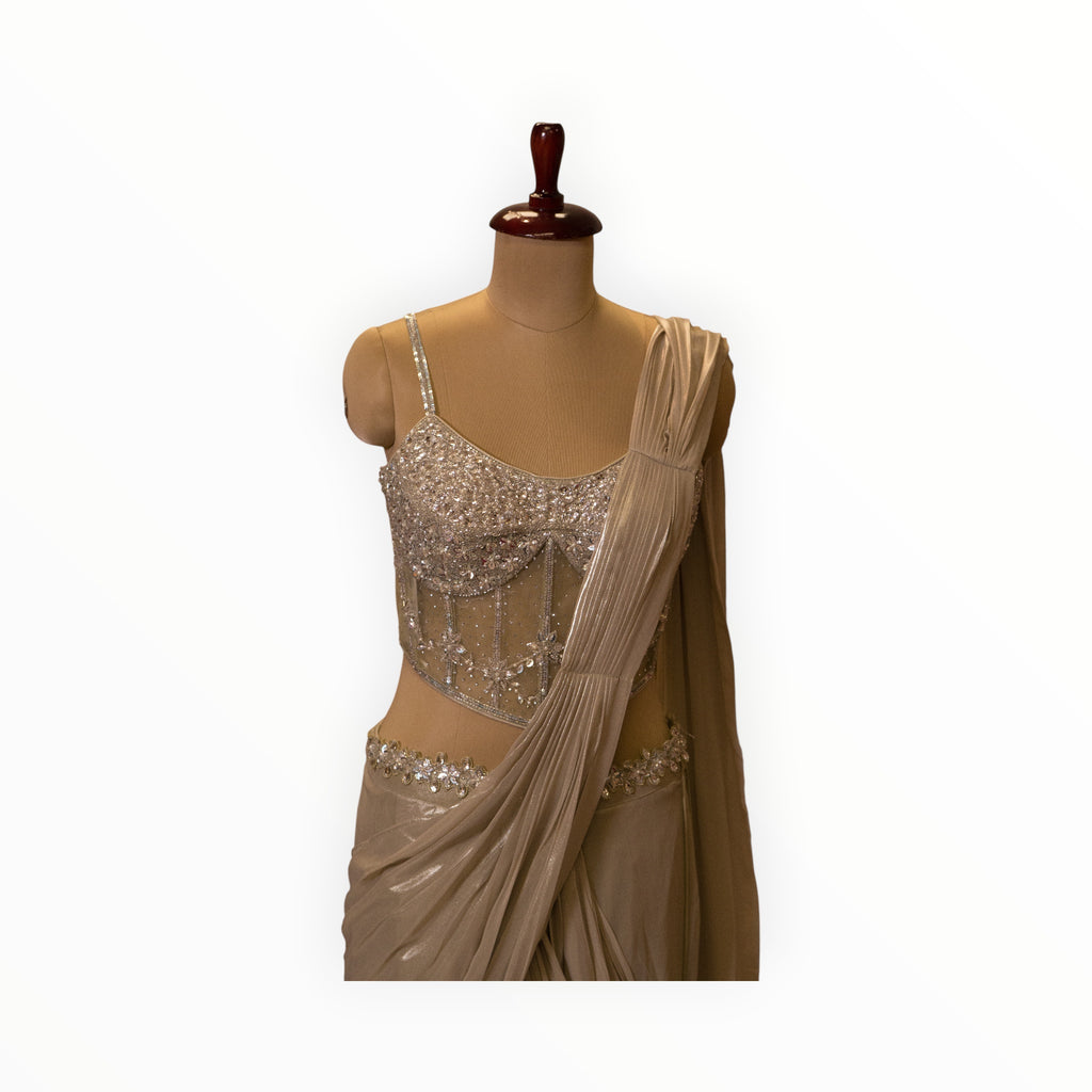 Zari Designs ready saree featuring a champagne-colored draped skirt and a corset-style blouse with silver embroidery.