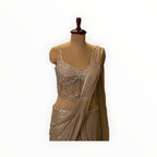Zari Designs ready saree featuring a champagne-colored draped skirt and a corset-style blouse with silver embroidery.