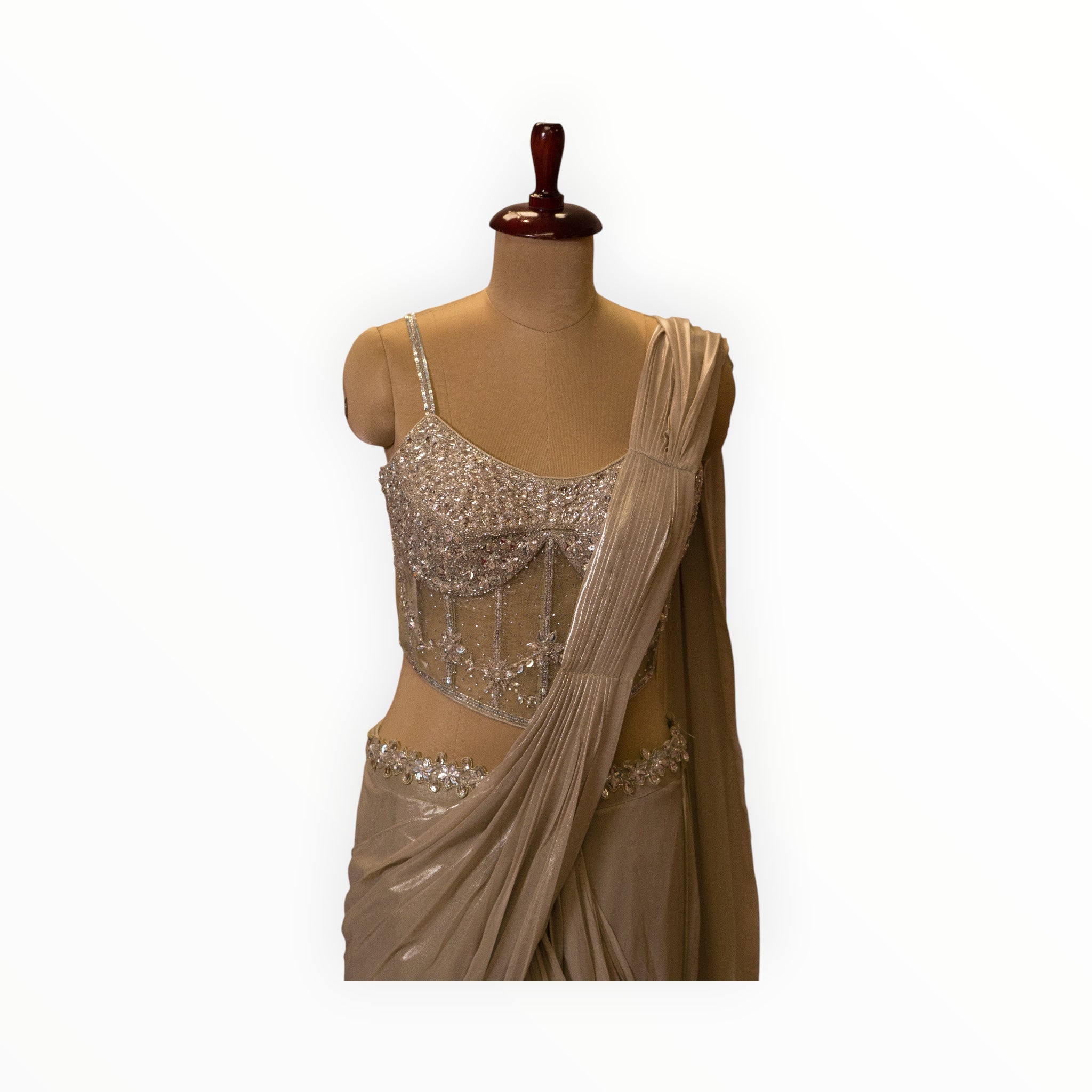 Zari Designs ready saree featuring a champagne-colored draped skirt and a corset-style blouse with silver embroidery.
