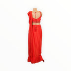 Back view of a Zari Designs red ready-to-wear saree with a sleeveless blouse, featuring delicate embroidery and tassels.