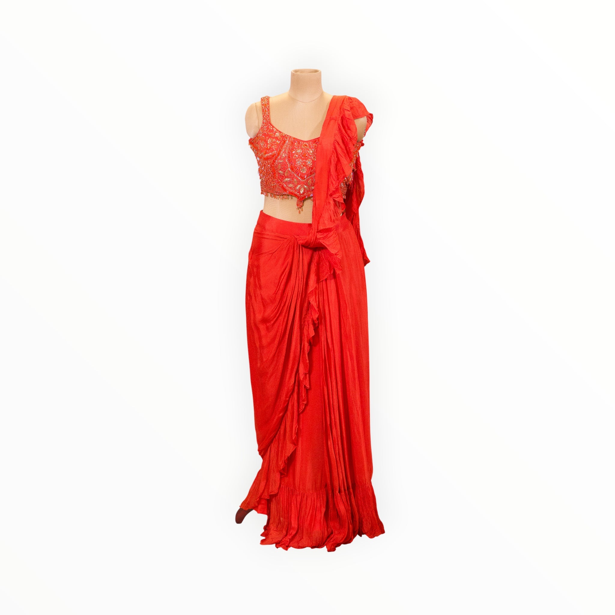 Zari Designs red ready-to-wear saree with a sleeveless embellished blouse and ruffled drape on a mannequin