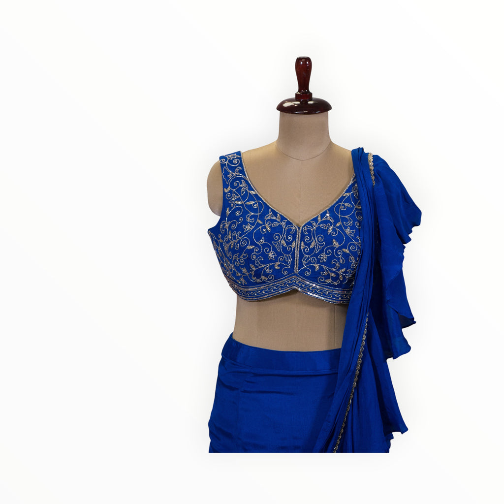 Zari Designs royal blue ready-to-wear saree featuring a sleeveless blouse with intricate silver floral embroidery.