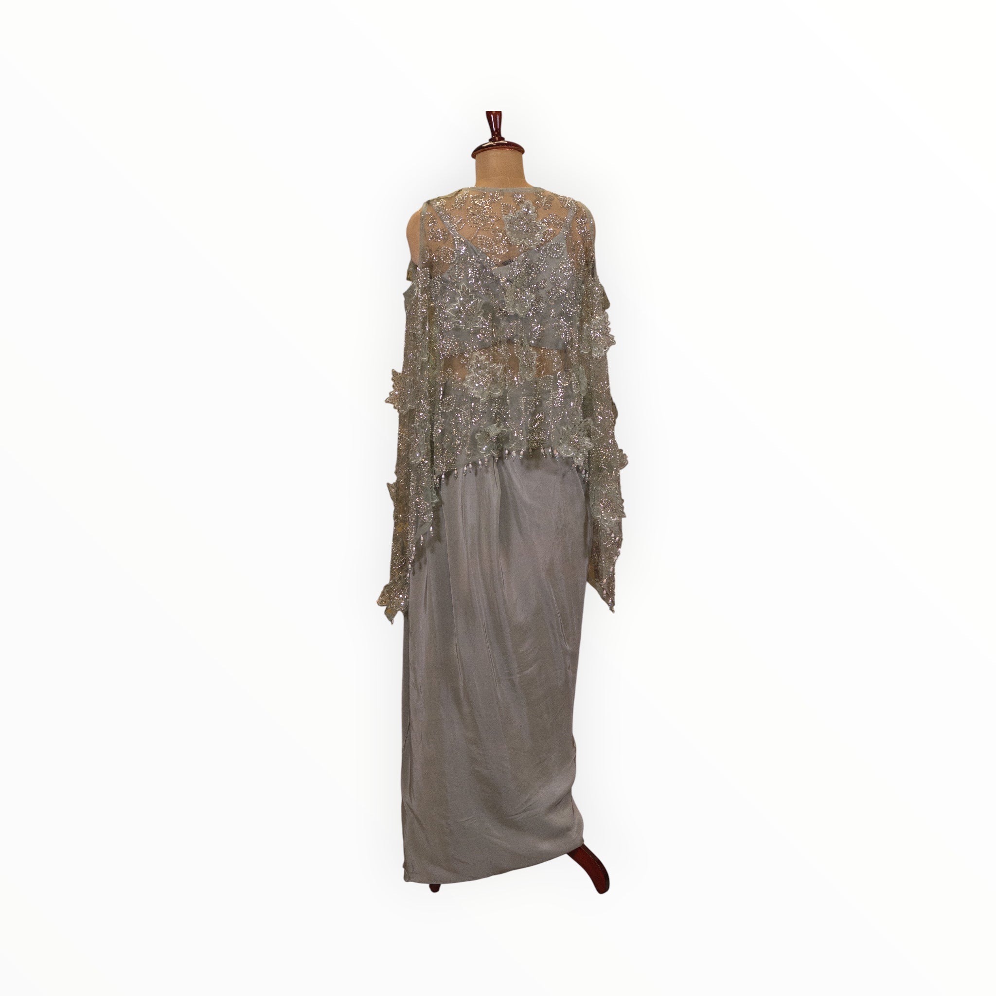 Zari Designs Indo Western crepe outfit featuring a sage green skirt and a sheer embellished cape with floral embroidery.