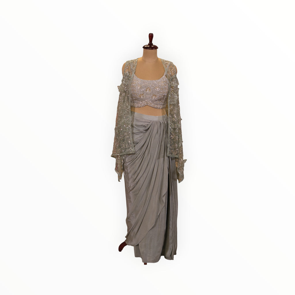 Zari Designs Indo Western crepe outfit featuring a silver embellished crop top, matching shrug, and draped skirt.