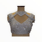 Zari Designs silver georgette ready drape saree blouse with intricate floral embroidery, sequins, and cut-out neck.