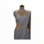 Zari Designs silver georgette ready drape saree with an intricately embroidered sleeveless blouse and choker neckline