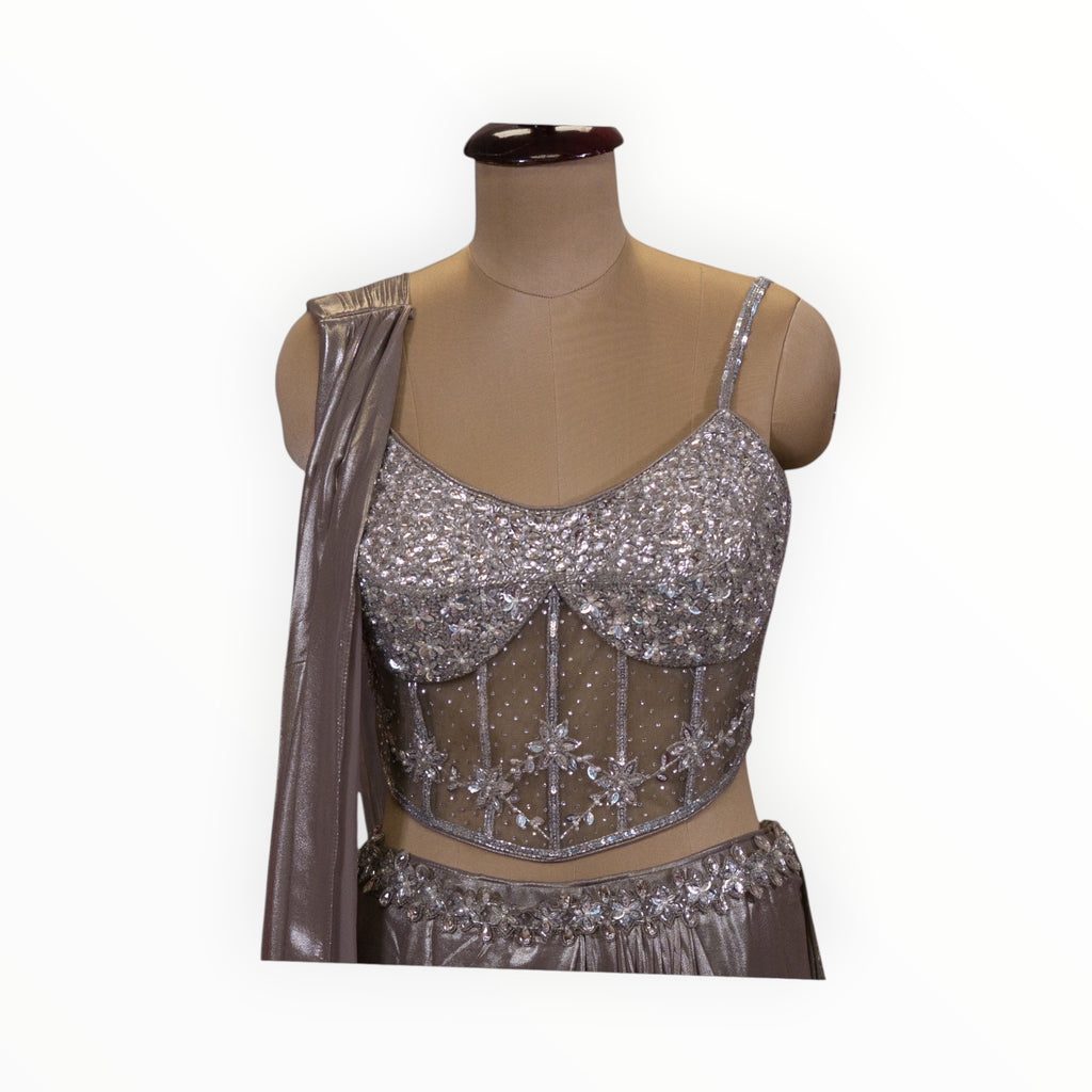 Zari Designs silver corset blouse with intricate sequin embroidery and sheer mesh detailing on a mannequin